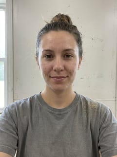 Nell as she photographed herself: grey T-shirt, bright room